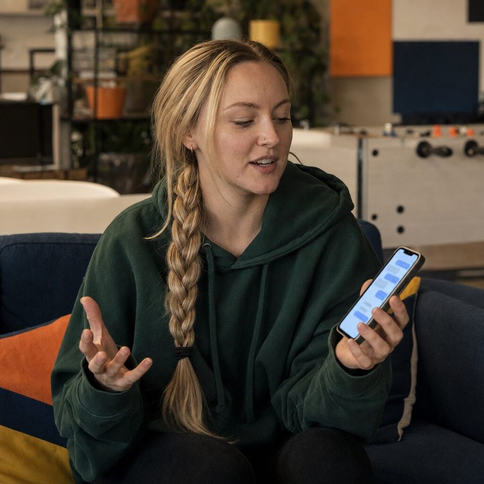 Illustrative photo: the technical lead at a small software agency asks the Code Review Agent for help from their phone.